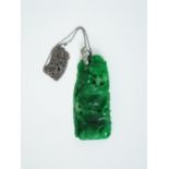 Early 20th century carved jade pendant depicting a fish and frog on a lily pad, the white metal bale