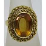 1970s 18ct ring set with a faceted citrine in plaited mount, maker D.J.E., size P, 7.4g