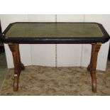 A Gothic revival oak writing table, the rectangular top with canted corners and later painted border