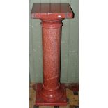 A three sectional polished granite pedestal, the square top raised on a turned pillar and square