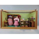 Miniature doll diorama of Edwardian ladies haberdashery store with two dolls in period clothes,