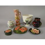 A collection of Moorcroft ceramics including a vase in the anemone pattern with impressed marks to