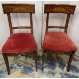 A pair of 19th century Dutch marquetry side chairs with repeating detail raised on sabre supports