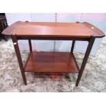 A good quality mid-20th century teak two tier occasional table, with removable tray top, raised on