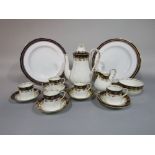 A collection of Royal Worcester coffee wares with gilt fruiting vine decoration on a white and