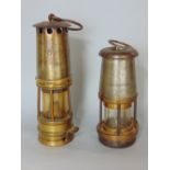 Two antique steel and brass miners lamps, the largest by The Wolf Safety Lamp Co, Sheffield, the
