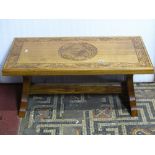 A low elm occasional table of rectangular form, the top with carved acorn and oak leaf detail,