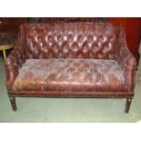 A good quality buttoned leather upholstered two seat sofa by HALO with studded seams and raised on