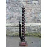 A mahogany standard lamp with spiral twist column raised on a swept square platform base, 140 cm