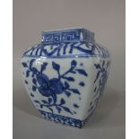 A 19th century oriental blue and white vase of four sided form with painted flower and branch