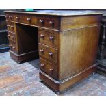 A small Victorian mahogany pedestal writing desk with inset top over an arrangement of nine