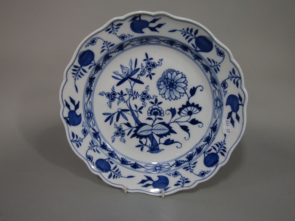 A 19th century Meissen type charger with blue and white painted floral decoration with blue cross