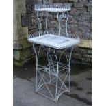 A wire work and light steel conservatory or garden plant stand on two graduated rectangular tiers,