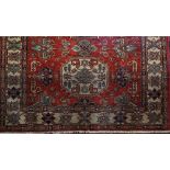 A good quality Persian wool carpet, the hexagonal blue medallion centre upon a red field with