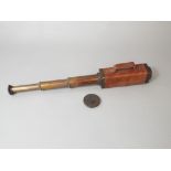 An unusual three draw telescope set in a square cut leather mounted frame - complete with lens cap -