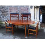 A retro teak D end extending dining table with single additional bi-fold leaf raised on four