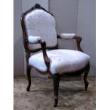 A 19th century fauteuil with cream ground floral patterned upholstered sprung seat and padded shield
