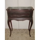 An Edwardian walnut planter freestanding and of rectangular form with moulded serpentine outline,