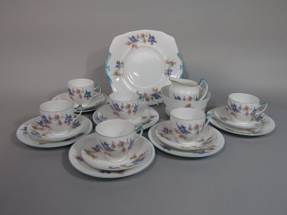 A collection of Royal Albert Crown China teawares with blue bird and blossom detail comprising