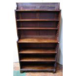 A 19th century mahogany waterfall bookcase fitted with six adjustable shelves and raised on short
