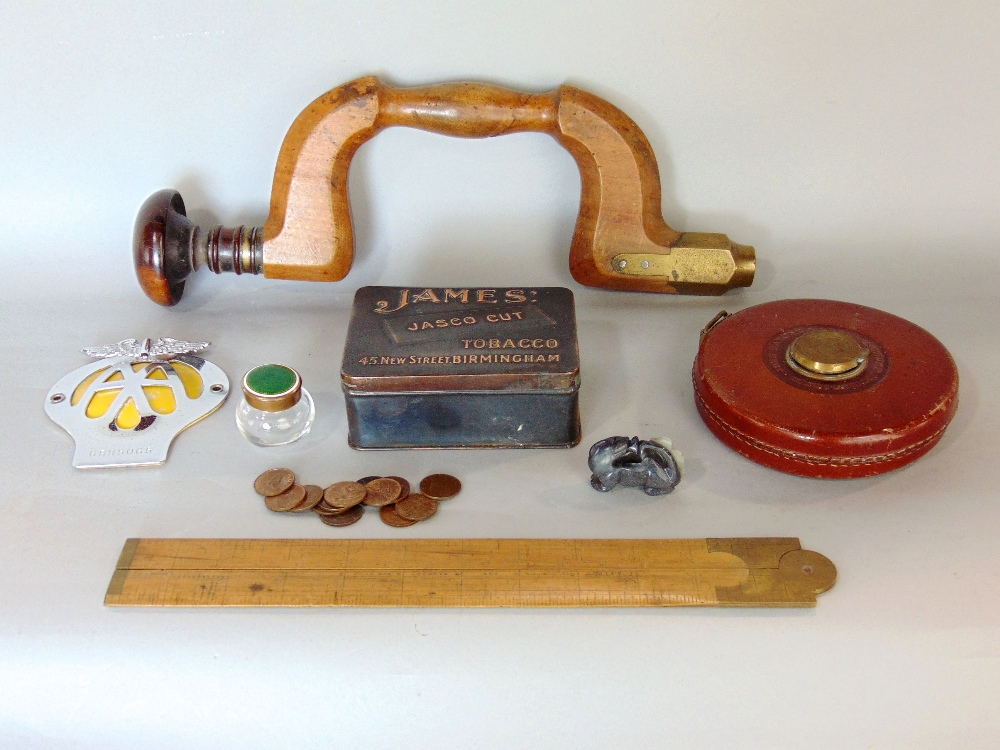 A mixed miscellaneous lot to include a leather wrapped tape measure, an enamel topped jar with