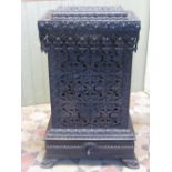 A good quality cast iron stove with decorative profuse pierced foliate detail, enclosed by a small