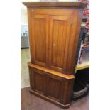 A substantial, good quality, oak free standing corner cupboard, enclosed by two pairs of panelled
