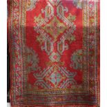 Turkish full pile runner, decorated with various green medallions upon a red ground, 400 x 120cm;