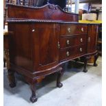 An Edwardian mahogany sideboard with gadroon moulded edge over a pair of bow-fronted cupboard