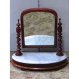 A Victorian mahogany toilet mirror of arched form, with spiral twist column supports and demi-lune