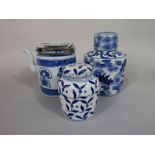 An oriental blue and white caddy of circular form with painted fish decoration, with blue seal