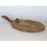 Robert Mouseman Thompson - Carved oak cheese board with typical carved mouse decoration, 37cm long