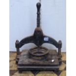 A small vintage cast iron paper or book press with central screw thread