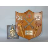 A shield shaped panel supporting two Krists and scabbards, presentation plaque inscribed '