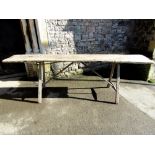 An antique rustic scrubbed plank table raised on four square tapering supports and stretchers, 252