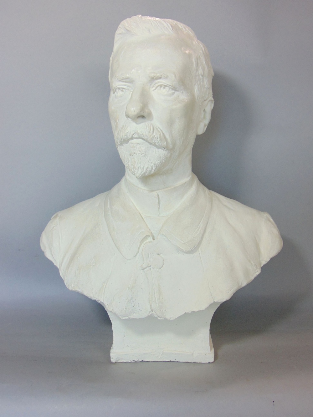 A painted plaster bust of an Edwardian male character