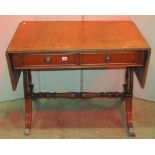 A reproduction Regency style sofa table, fitted with two real and two dummy frieze drawers, raised