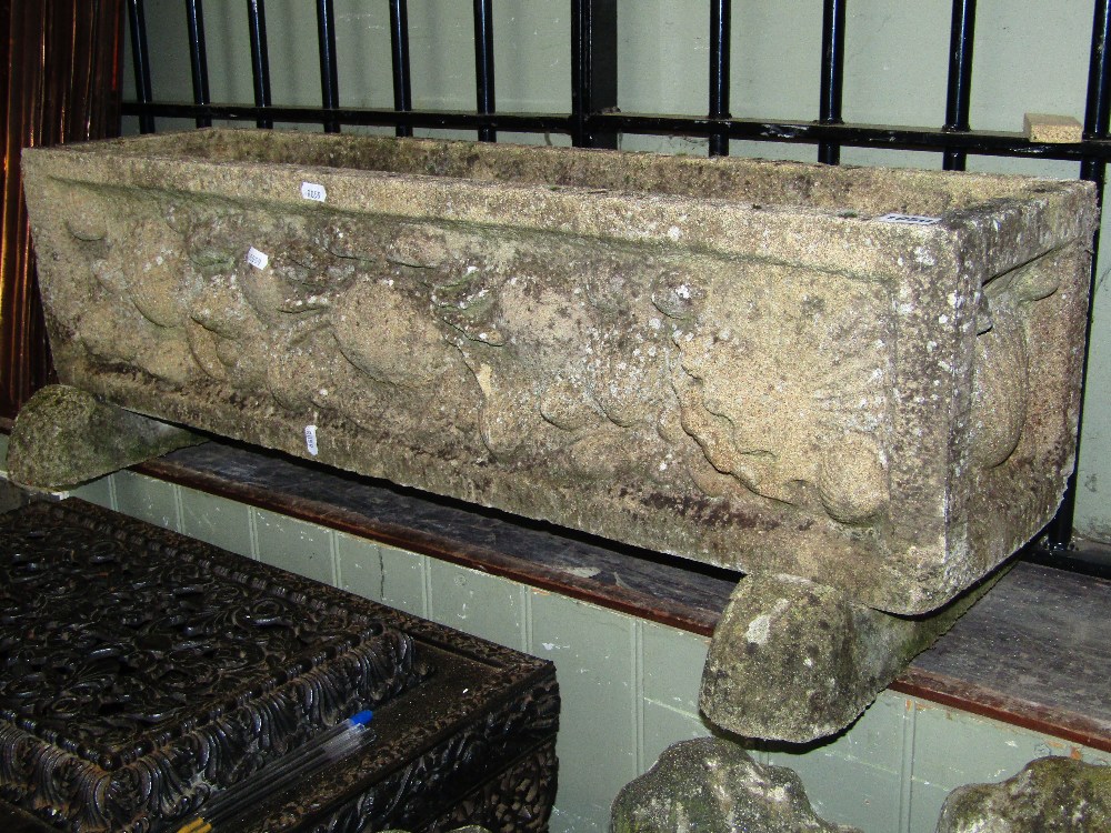 A weathered cast composition stone planter of rectangular form, with raised crab and shell relief
