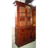 A Victorian mahogany library bookcase, the upper recessed section with moulded cornice over a pair