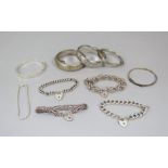Mixed lot of silver bracelets / bangles comprising a cast hinged bangle of scrolled design - maker B