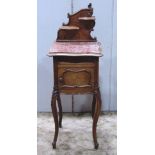 A late 19th century French walnut veneered bedside table, the top with moulded serpentine outline,