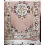 Eastern wool full pile rug/runner with central floral medallion upon a Salmon ground, 160 x 90cm