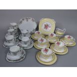 A collection of New Chelsea Staffordshire floral teawares with yellow border decoration,