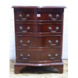 A small reproduction Georgian style chest with serpentine front fitted with four long drawers raised