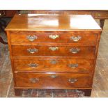 A small Georgian mahogany chest of four long graduated drawers with brass plate handles and