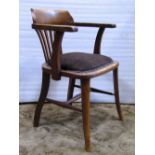 A pair of early 20th century oak desk chairs, the bow backs with shaped and tapered splats over