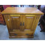 A good quality low oak side cupboard enclosed by a pair of rectangular fielded panelled doors
