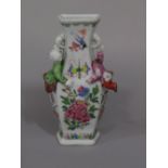 An unusual 19th century oriental wall pocket in the form of a vase with applied figures of