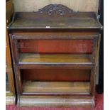 An oak floor-standing two sectional library bookcase, enclosed by a pair of up and over