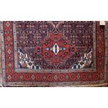 Quashqai rug with three medallion decoration, with geometric design upon a red ground, 195 x 140cm